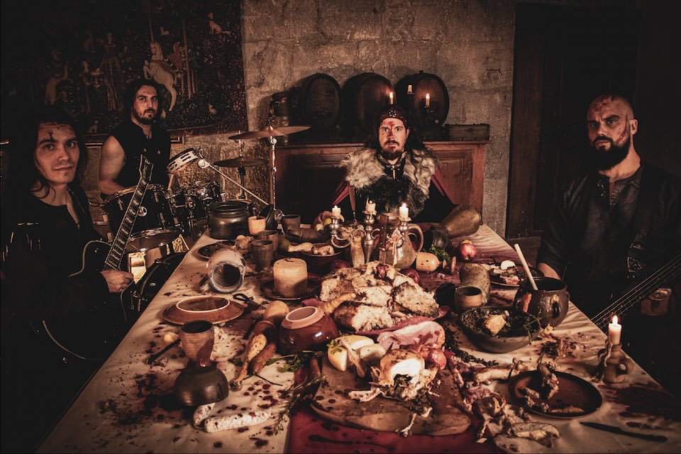 The band members around a banquet table.